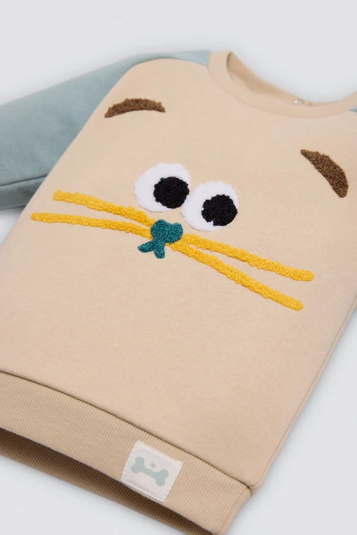 Conjunto de chándal bebé gato beige y azul con huellas en rodillas