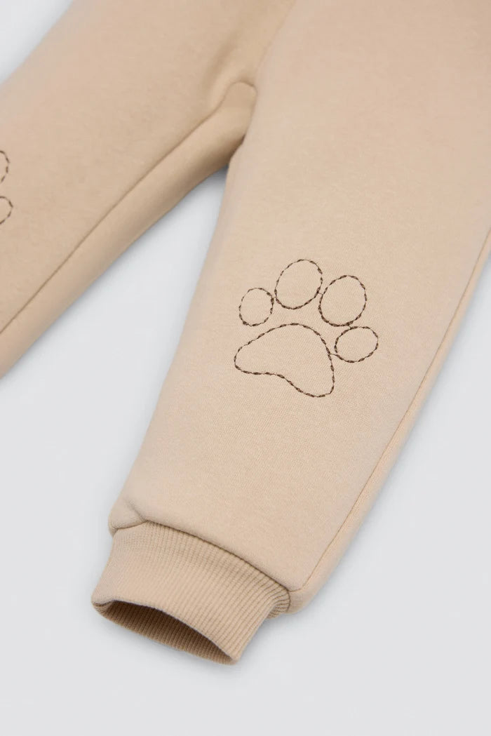 Conjunto de chándal bebé gato beige y azul con huellas en rodillas